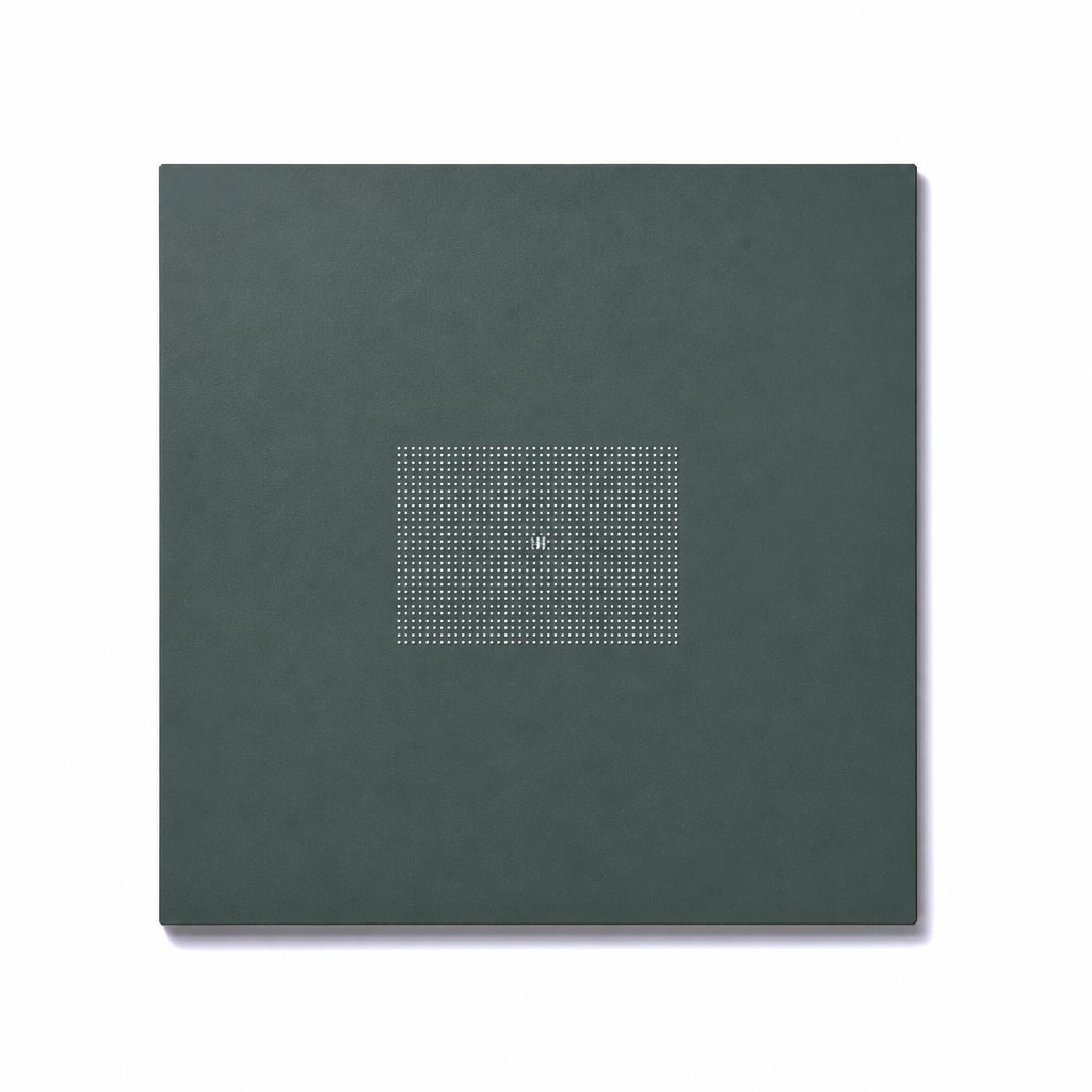 Top-down view of a dark green BGA package underside with a ball array and a tiny center mark, on white